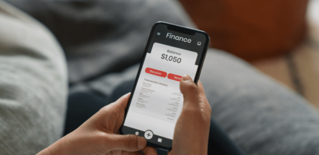 A photo of a smart phone with a finance app opened to promote the use of financial planning apps to save, spend and invest responsibly.