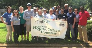 Group with HomeAid Banner