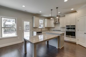beautiful kitchen with stainless vent hood