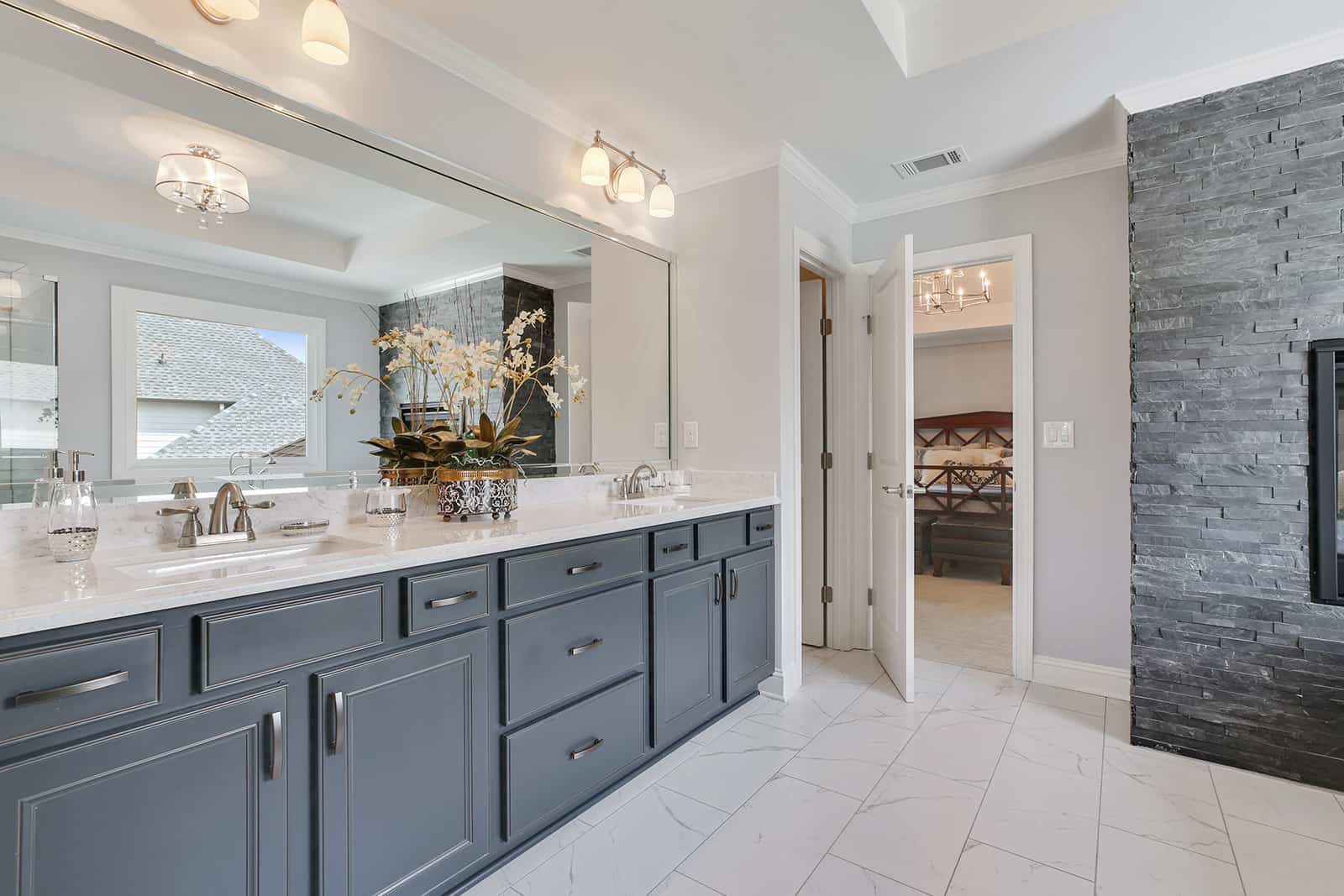 luxurious owners suite bathroom with dual vanities, soaking tub and frameless shower