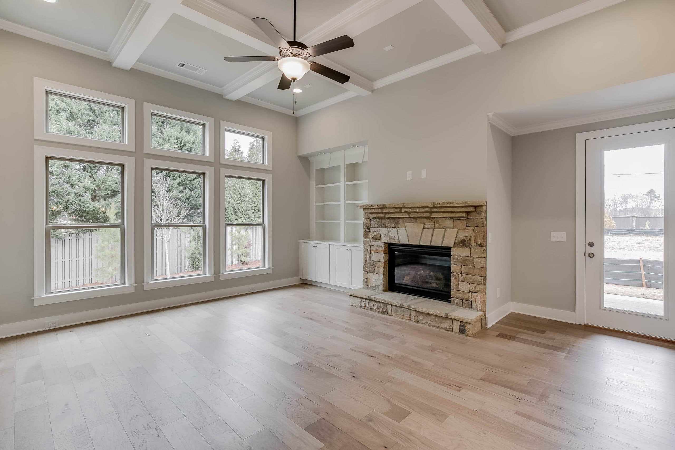 SR Homes Stone Fireplace Coffered Ceiling
