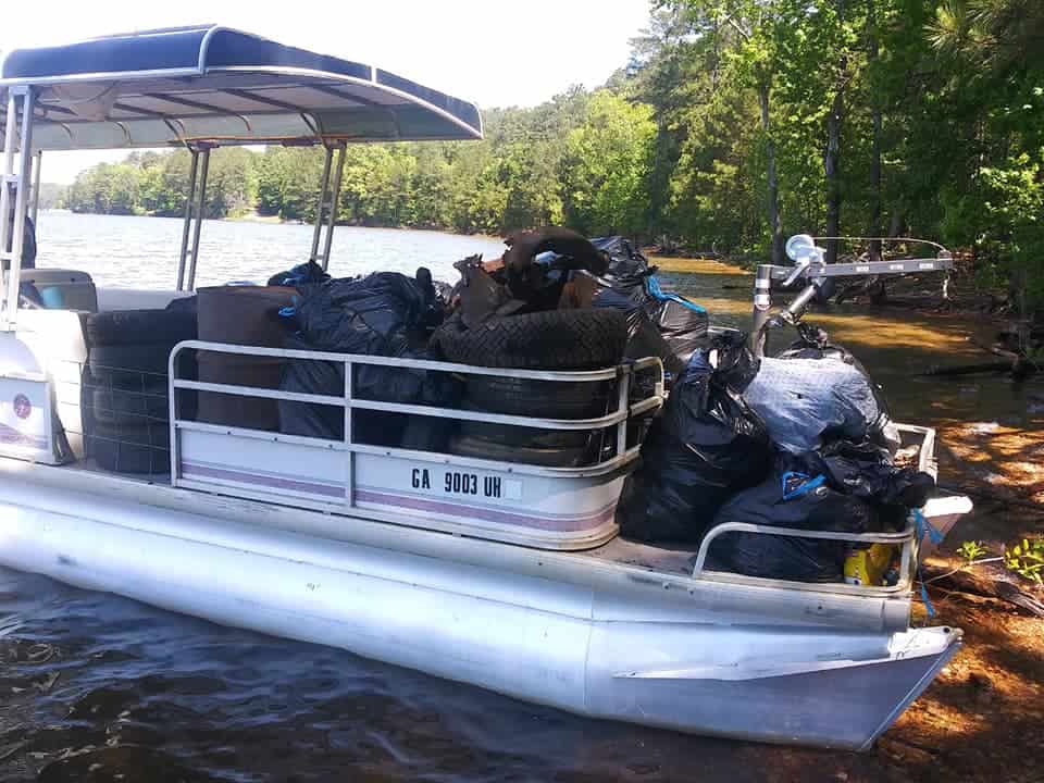 Lake Warriors work boat filled with Little River trash at The Great Lake Allatoona Cleanup