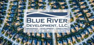 Blue River Development logo over a community of homes