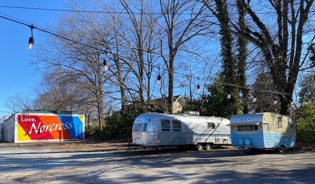 Airstream trailer and 1962 Shasta trailer with Love Norcross sign