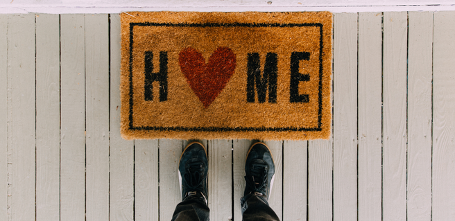 door mat that says home with pair of boots to represent the Atlanta market overview