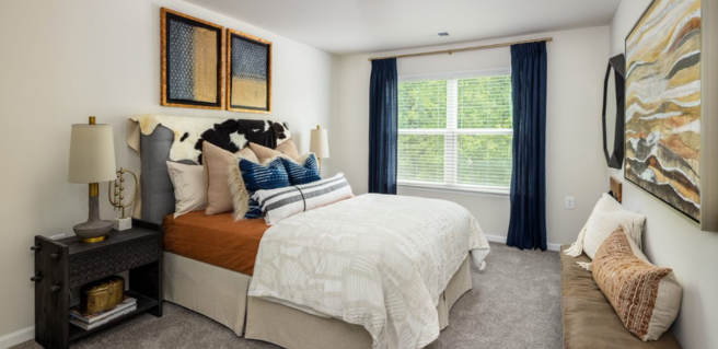 The Cottages at Walker Ridge bedroom with white walls and gray carpeting