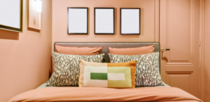 Room with peach walls and a peach bed to depict the 2024 color of the year selections