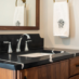 Black Marble sink with silver hardware and a dark wooden vanity - All Concepts Sink Care