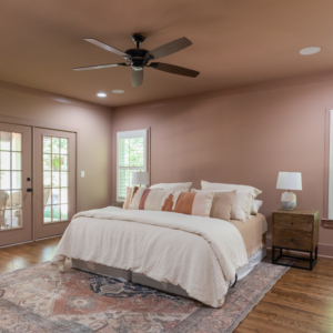 Cartersville bedroom with brown walls and bed and wooden floors