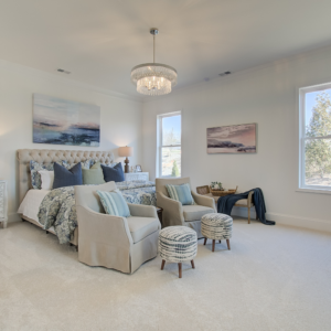 Courtyards at Traditions model home owner's bedroom with tall ceilings and white walls
